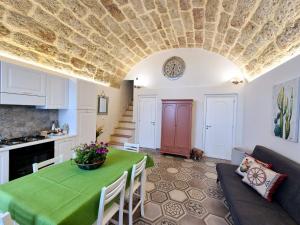 a living room with a table with a green table cloth at Azzurra Home in Terrasini