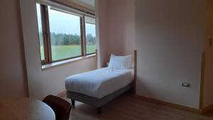 Postel nebo postele na pokoji v ubytování Calafate Apart Hotel
