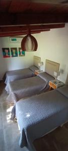 Een bed of bedden in een kamer bij Sierras Chicas Casa de Campo