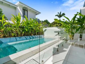 a swimming pool on the balcony of a house at Noosa Dreaming in Noosa Heads