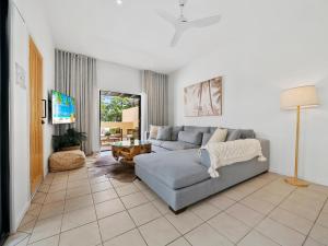 a living room with a couch and a table at Noosa Dreaming in Noosa Heads