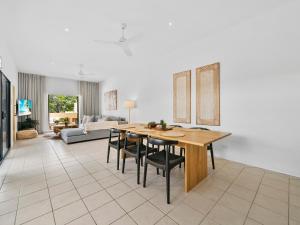a kitchen and living room with a table and chairs at Noosa Dreaming in Noosa Heads