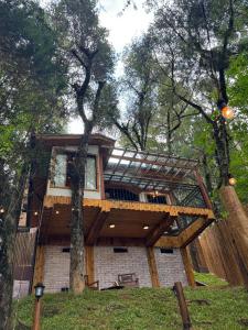 a tree house in the middle of a forest at Estalagem Serra de Minas em Monte Verde in Monte Verde