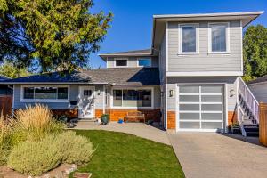 a house with a white garage door at LOCATION LOCATION LOCATION IMMACULATE 1 BEDROOM SUITE in Victoria