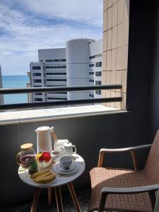 a tray of food on a table on a balcony at Flat Saint martin 1807 in Fortaleza