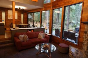 a living room with a couch and a glass table at Mountainview Lodge in Deming