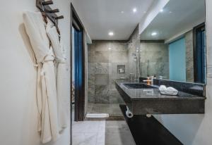 a bathroom with a sink and a shower at Soho Playa Hotel in Playa del Carmen