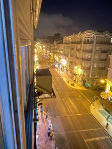 a view of a city street at night from a window at Quarto Alameda in Lisbon