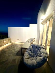 a balcony with a bean bag chair and a table at The Dice in Pachaina