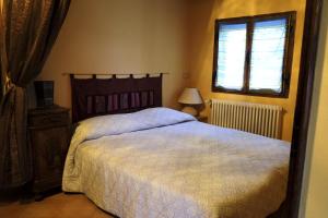 a bedroom with a large bed and a window at B&B Ca'del Gallo in Novafeltria