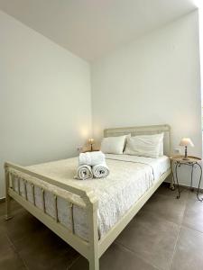 ein Schlafzimmer mit einem Bett, auf dem zwei Handtücher liegen in der Unterkunft The Dice in Pachaina