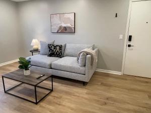 a living room with a couch and a table at Joslyn 6-Cozy in Midtown Omaha in Omaha