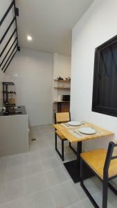 a dining room with a table and a tv at B House Phuket @Chalong in Chalong 