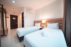 Postel nebo postele na pokoji v ubytování Travelbee Minglanilla Inn + 6 fotografií
