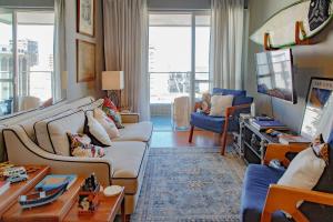 a living room with two couches and a table at Leblon Flat Service 2 Bedrooms Sea View in Rio de Janeiro +41 photos