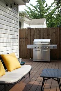 a patio with a grill on a wooden deck at Modern, Pet-Friendly Retreat, Named Best BnB in Bham in Birmingham