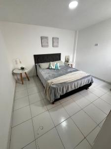 a bedroom with a bed and a tiled floor at Del Estero in Santiago del Estero