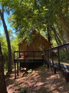 a small wooden cabin in the woods with trees at Habitación privada matrimonial, Vilches in Vilches