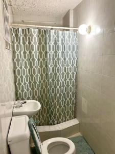 a bathroom with a shower and a toilet and a sink at Steps 2 Beach - 5 Bedroom 3 Bathroom Villa in Christ Church +26 photos