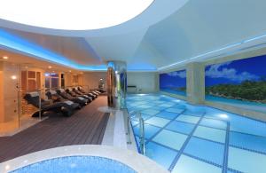 a swimming pool in a house with a couch and a couch at Latanya Hotel Ankara in Ankara