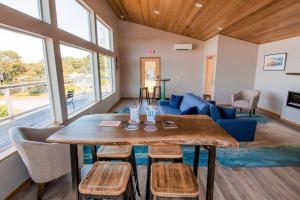 a living room with a table and a blue couch at Driftwood - Tiny Tranquility on the Oregon Coast in Waldport