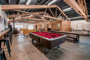 a billiard room with a pool table and tables at Shorepine - Tiny Tranquility on the Oregon Coast! in Waldport