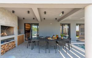 a kitchen and dining room with a table and chairs at Gorgeous Home In Zadar in Zadar