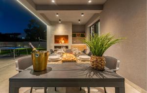 a dining room table with a bottle of wine and a pineapple at Gorgeous Home In Zadar in Zadar +38 photos