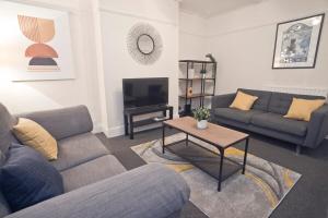 a living room with two couches and a table at October Disc - Long Stay - Contractors in Bristol