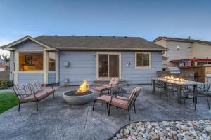 une terrasse avec des chaises et un foyer extérieur en face d'une maison dans l'établissement Mountainside View Firepit & Hot Tub, à Colorado Springs