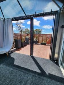 an open glass door of a balcony with a patio at Our Casetta in Richmond +2 photos