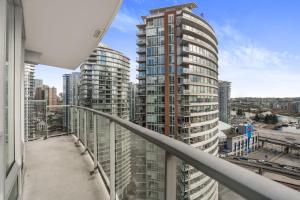 a view from the balcony of a building with tall buildings at Sleek 2BR Getaway Urban Pulse Waterfront Tranquility in Vancouver