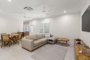 a living room with a couch and a table at Sandscapes Sanctuary in Broome