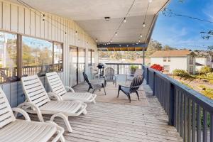 a porch with chairs and a grill on it at Evergreen in Depoe Bay