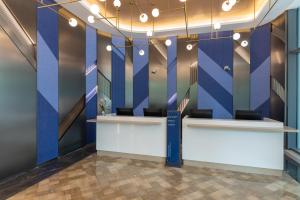 a lobby with blue walls and a reception desk at Holiday Inn Express Changfeng Park in Shanghai +34 photos
