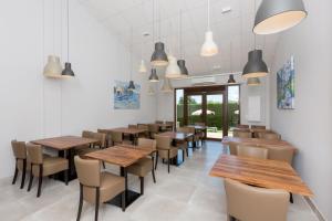 a dining room with wooden tables and chairs at Hotel Fortuny javea in Jávea