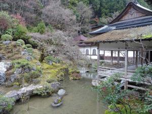 an asian garden with a building and a stream at Kyoto - House / Vacation STAY 14527 in Kyoto