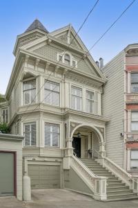 a large house with a garage in front of it at Historic & Charming Victorian Home Sleeps 11 in San Francisco