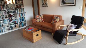 a living room with a couch and a chair at Leigh Panorama B&B in Leigh