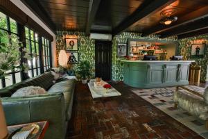 a living room with a couch and a bar at Villa Royale in Palm Springs