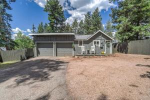 a house with a garage and a fence at 1BR Woodland Hideaway - Downtown and Hiking Nearby in Woodland Park