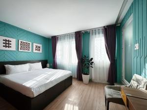 a bedroom with a large bed and a couch at Your Second Home - Garden House in center of Dalat in Da Lat