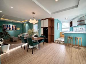 a kitchen and dining room with a table and chairs at Your Second Home - Garden House in center of Dalat in Da Lat