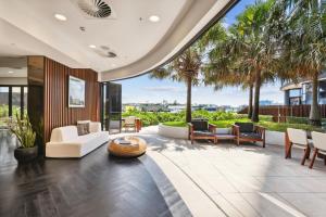 an open living room with a view of the ocean at Chic 2-Bed with Skyline Views Pool and Gym in Brisbane