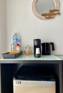 a shelf with a coffee maker on top of a microwave at Pátio Abílio Guest House in Nazaré