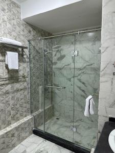 a shower with a glass door in a bathroom at Tuya Queen Pyramids View in Cairo