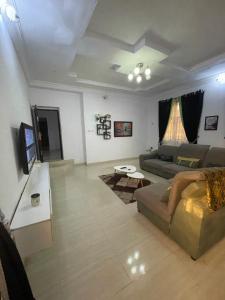 a living room with a couch and a table at 1 bedroom apartment in Ibadan