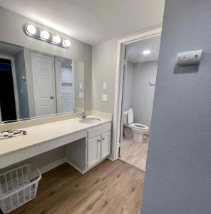 y baño con lavabo y aseo. en Cozy Aksarben Living-close to I-80 & WFH desk, en Omaha