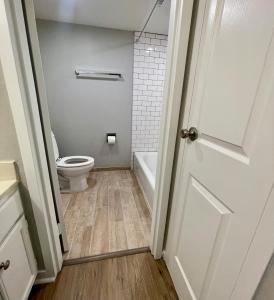 a bathroom with a toilet and a bath tub at Cozy Aksarben Living-close to I-80 & WFH desk in Omaha