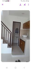 d'une petite salle de bains avec un lavabo et un escalier. dans l'établissement Grae’s Apartelle, à Moalboal